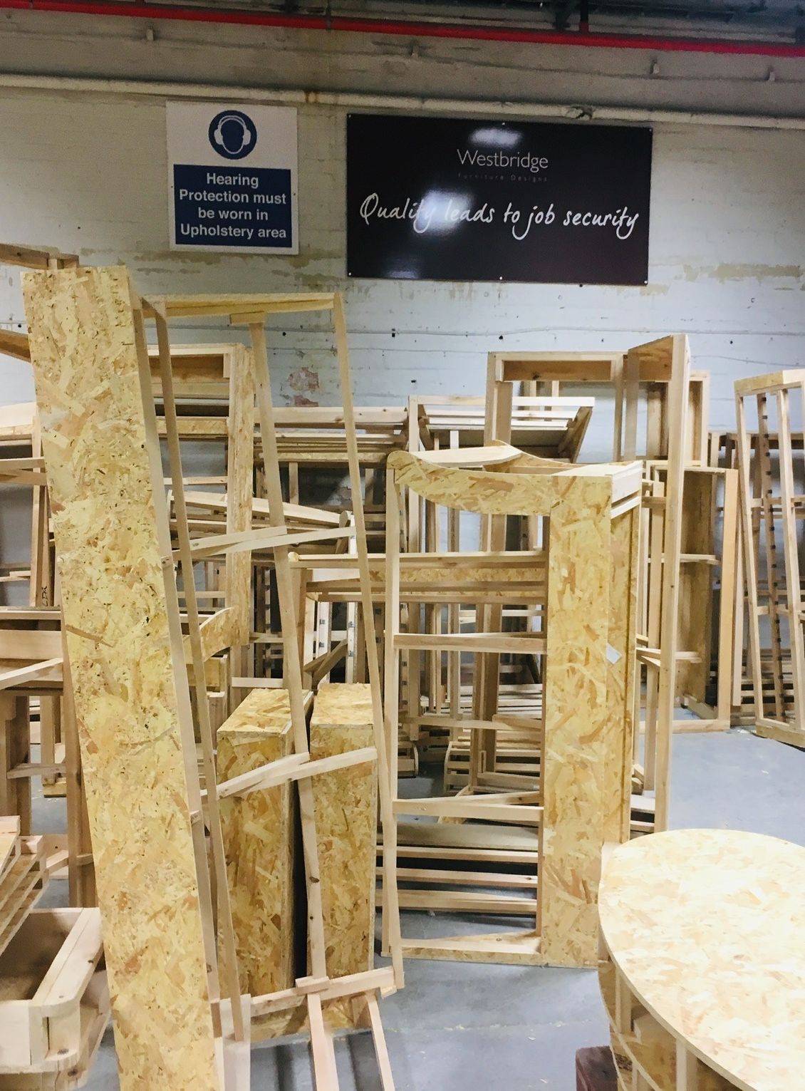 Stacks of unfinished wooden sofa frames