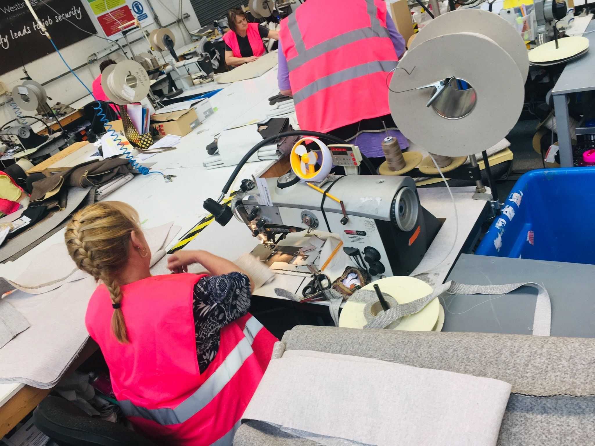 Machinists sewing upholstery at the factory